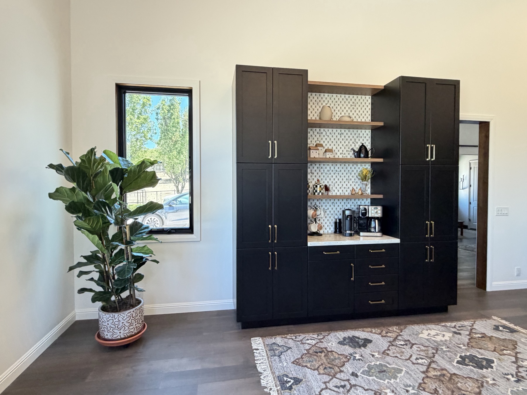 Built-in coffee bar with navy cabinetry and white oak shelving